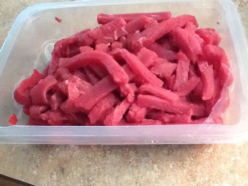Finely slice the lean beef strips.