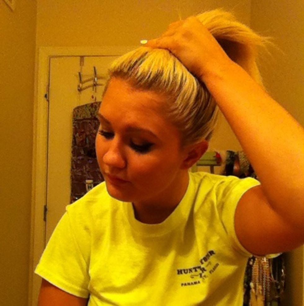 Finger comb your hair into a high pony tail