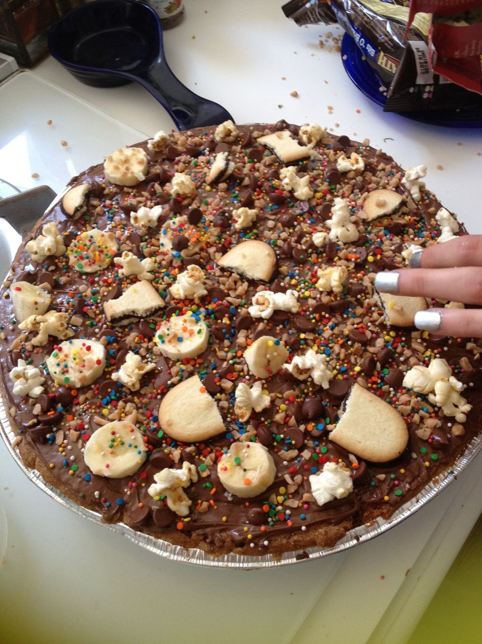 Finish adding toppings! We added kettle corn, bananas, toffee, sprinkles, cookies and chocolate chips! Or us oreos pretzels strawberries or marshmallows!