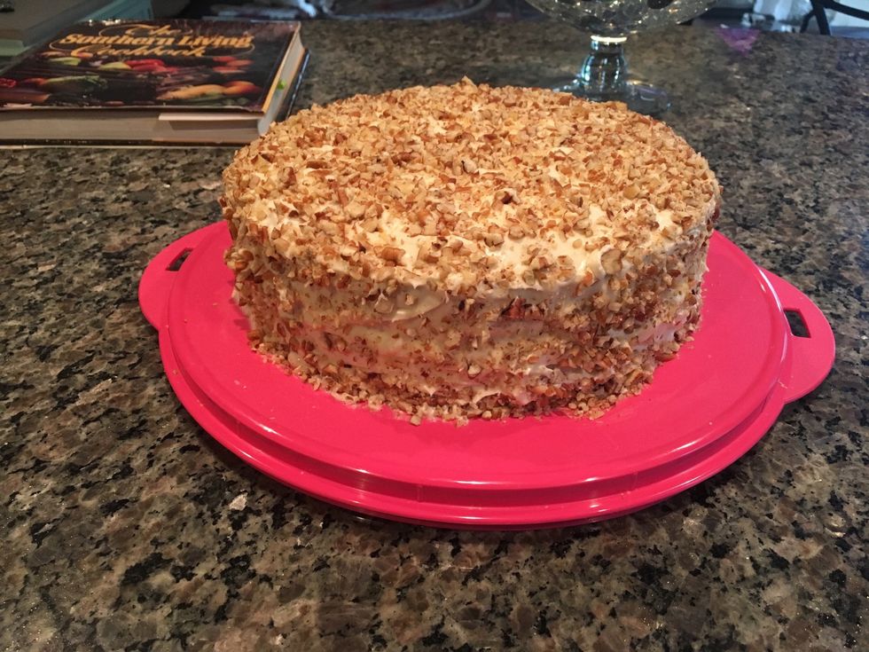 Finish by cleaning up the sides of the container with a wet paper towel to remove any access icing or pecans. Enjoy!