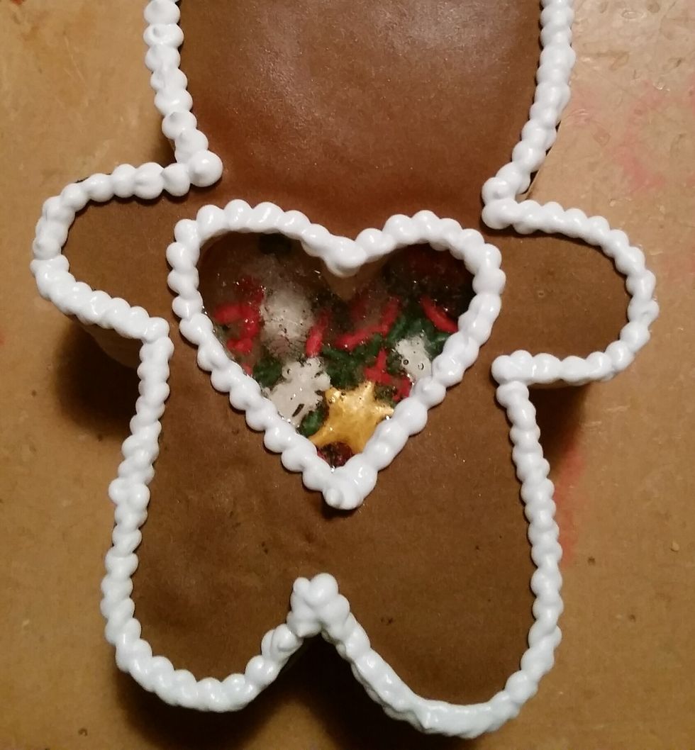 Finish decorating the cookie people with details. Place the different color royal icings in piping bags with tips and decorate until your content :) Look how cute!