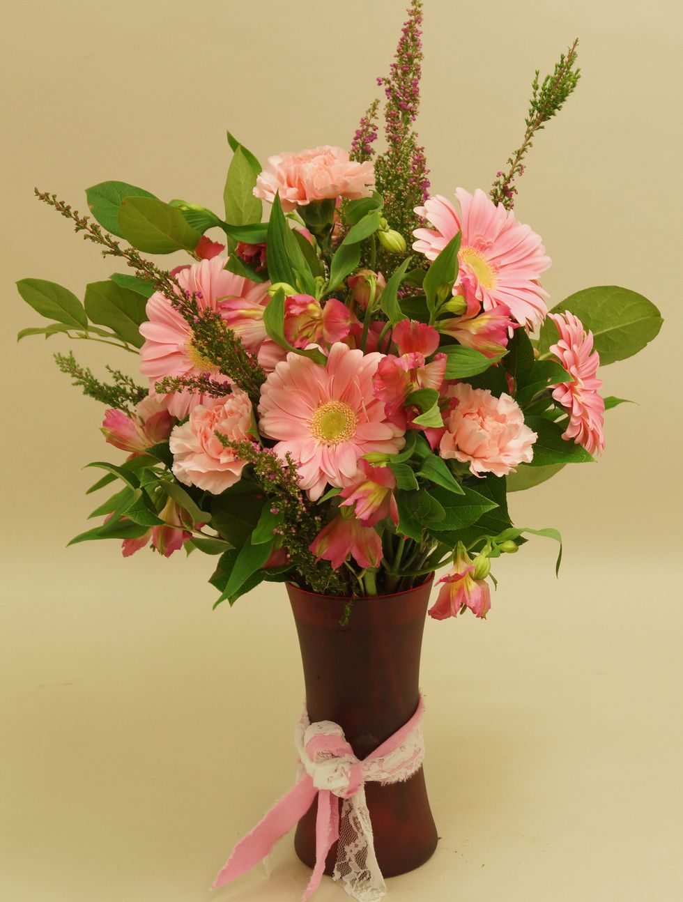 Finish design by adding heather into the arrangement.
