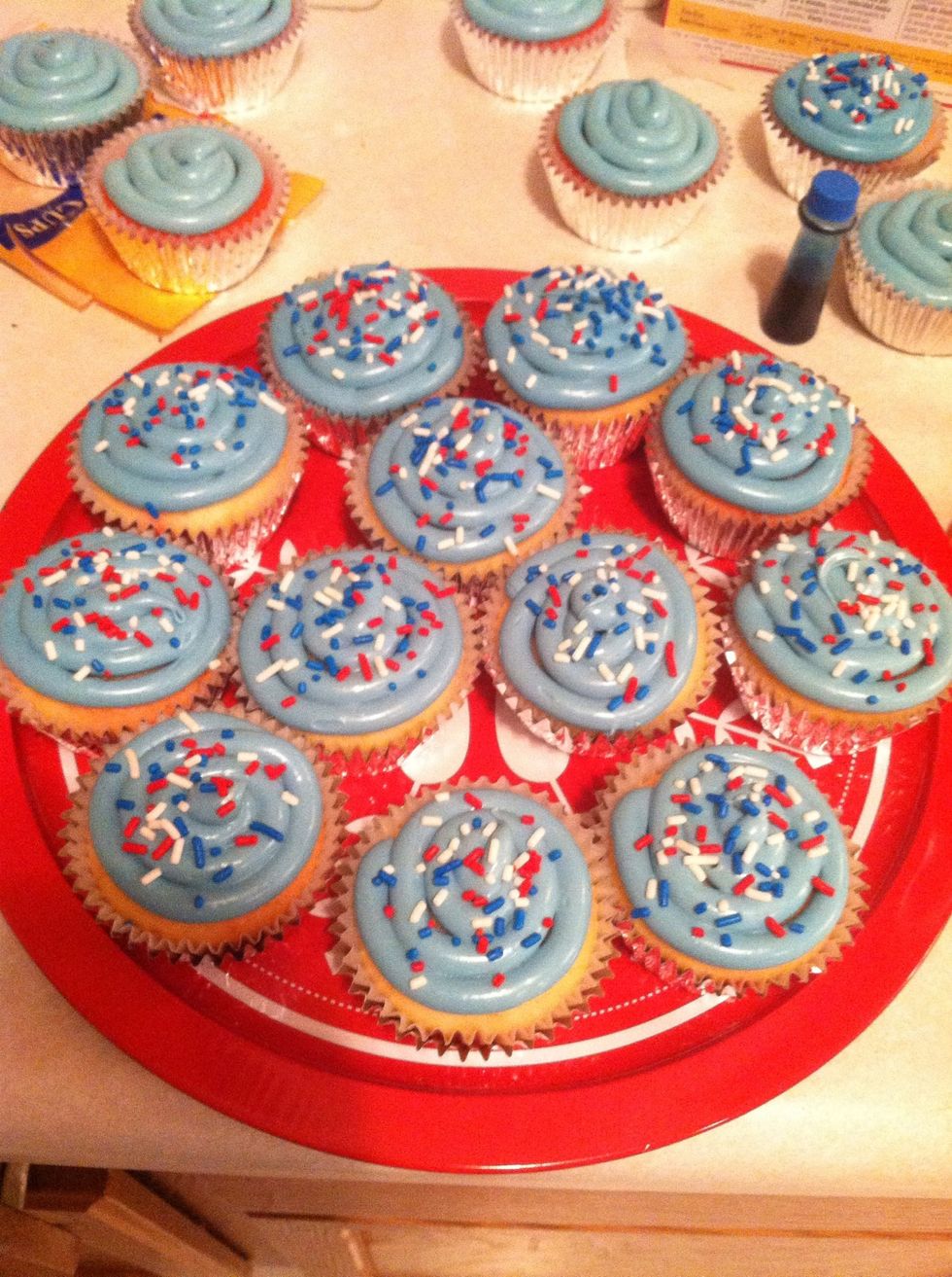 Finish frosting the rest of the cupcakes and then sprinkle with patriotic-colored sprinkles.