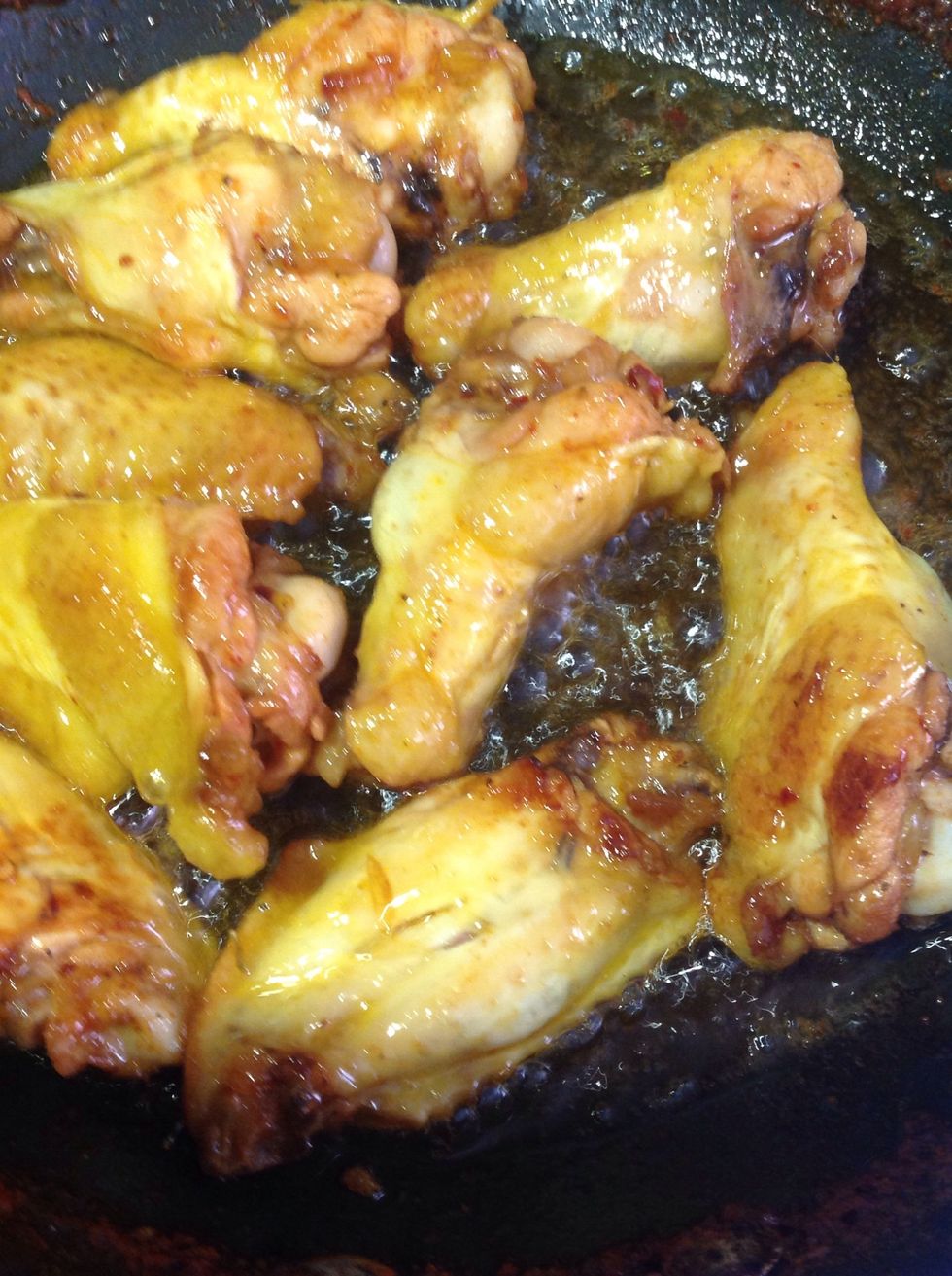 Finish frying the wings, so they cook all the way and have that golden color, once the sauce is reduce add the wings to the pan and cook it for 5 mins