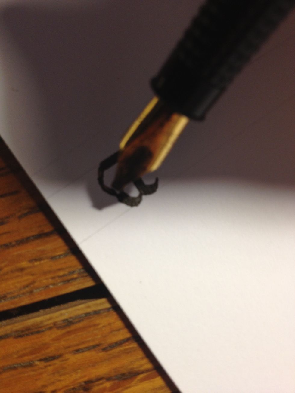 Finish it off by drawing a thick stroke from the top of the trunk across the top line, then making a thin curve into the second stroke. A bit of pen manipulation is needed to keep the curve thin.