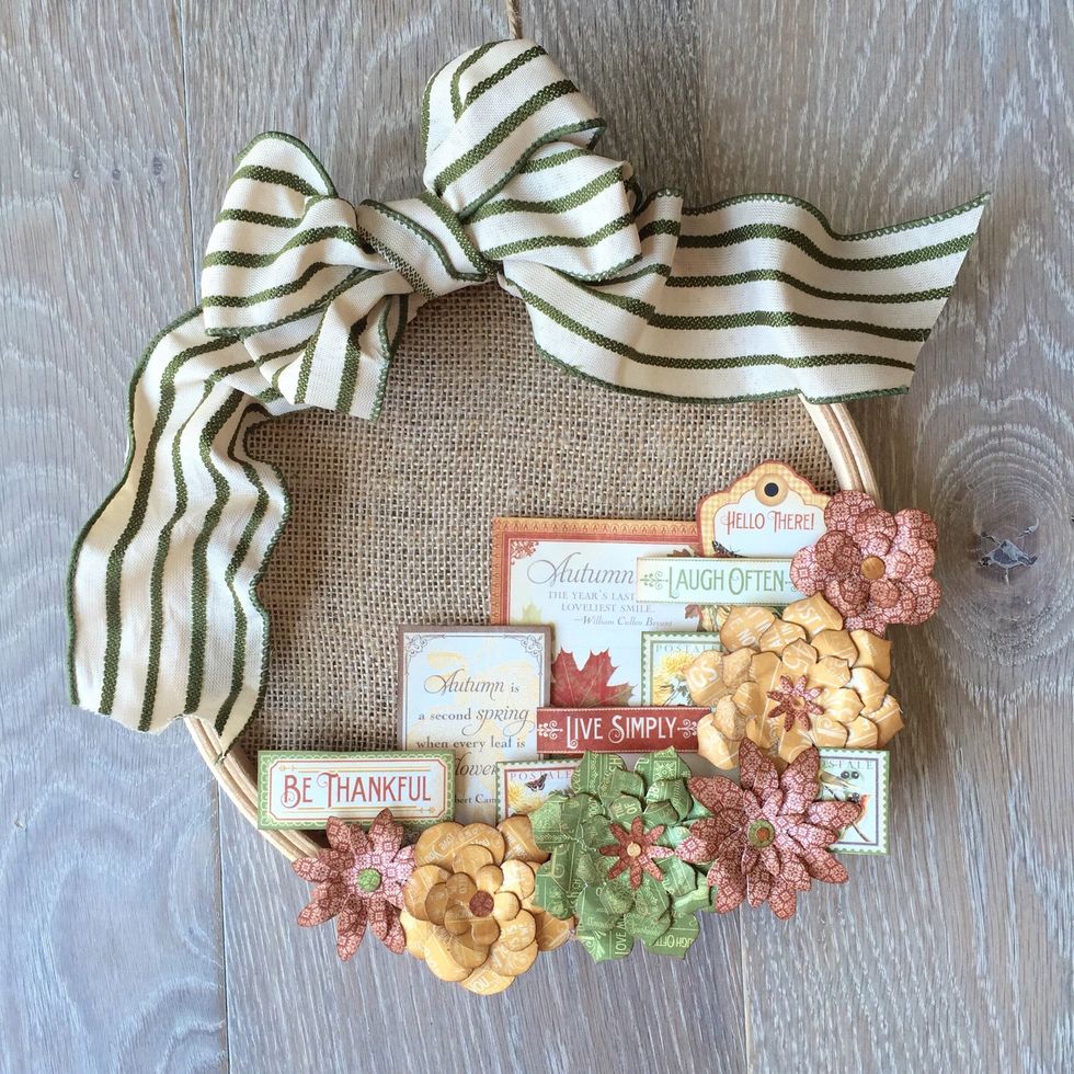 Finish layering paper cut outs. Add ribbon by making a bow or looping through hoop, as desired.