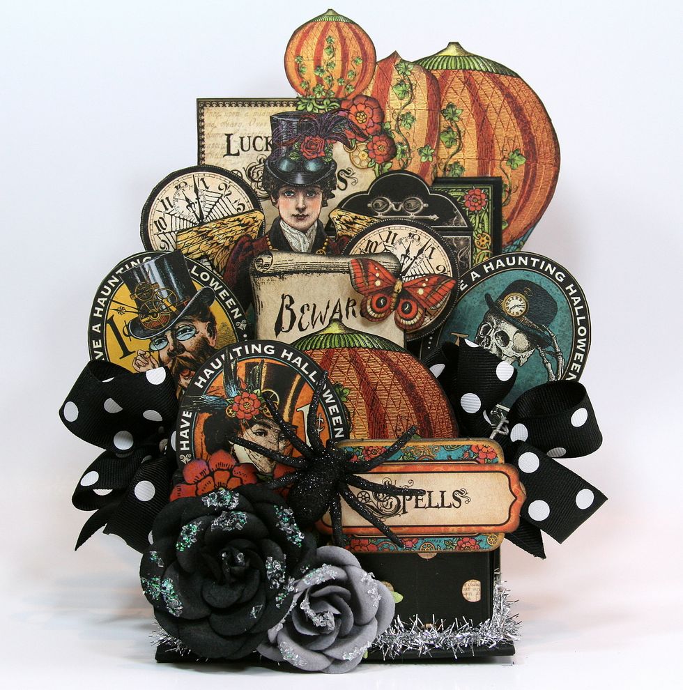 Finish off the front of the box with flowers and glittery spider.