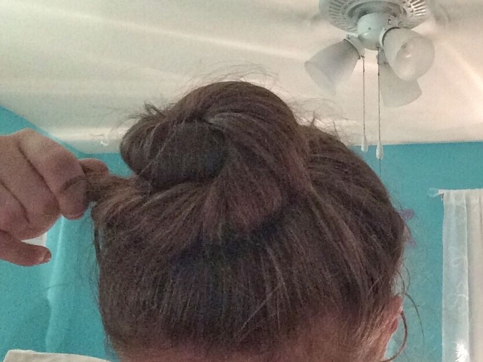 Finish pulling and wrapping your hair around the pony tail and bobby pin this last section.