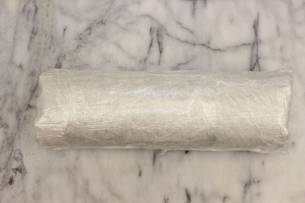 Finish rolling the cake with parchment paper and than cover tightly with clear plastic wrap. Make sure the seam is on the bottom and your design is on the top. Refrigerate/freeze to firm up the cake.