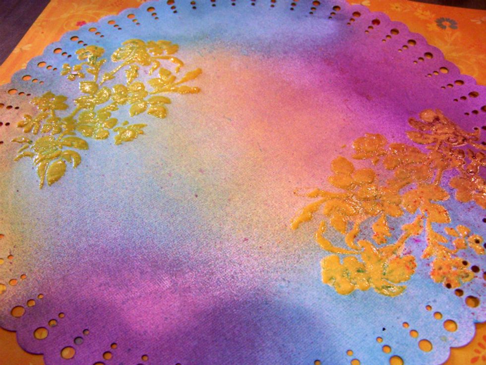 Finish spraying the background wiping off excess and blending colors with a paper towel.
