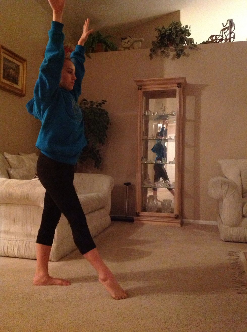 Finish standing in an upright position with arms by your head and ending up right where you started.