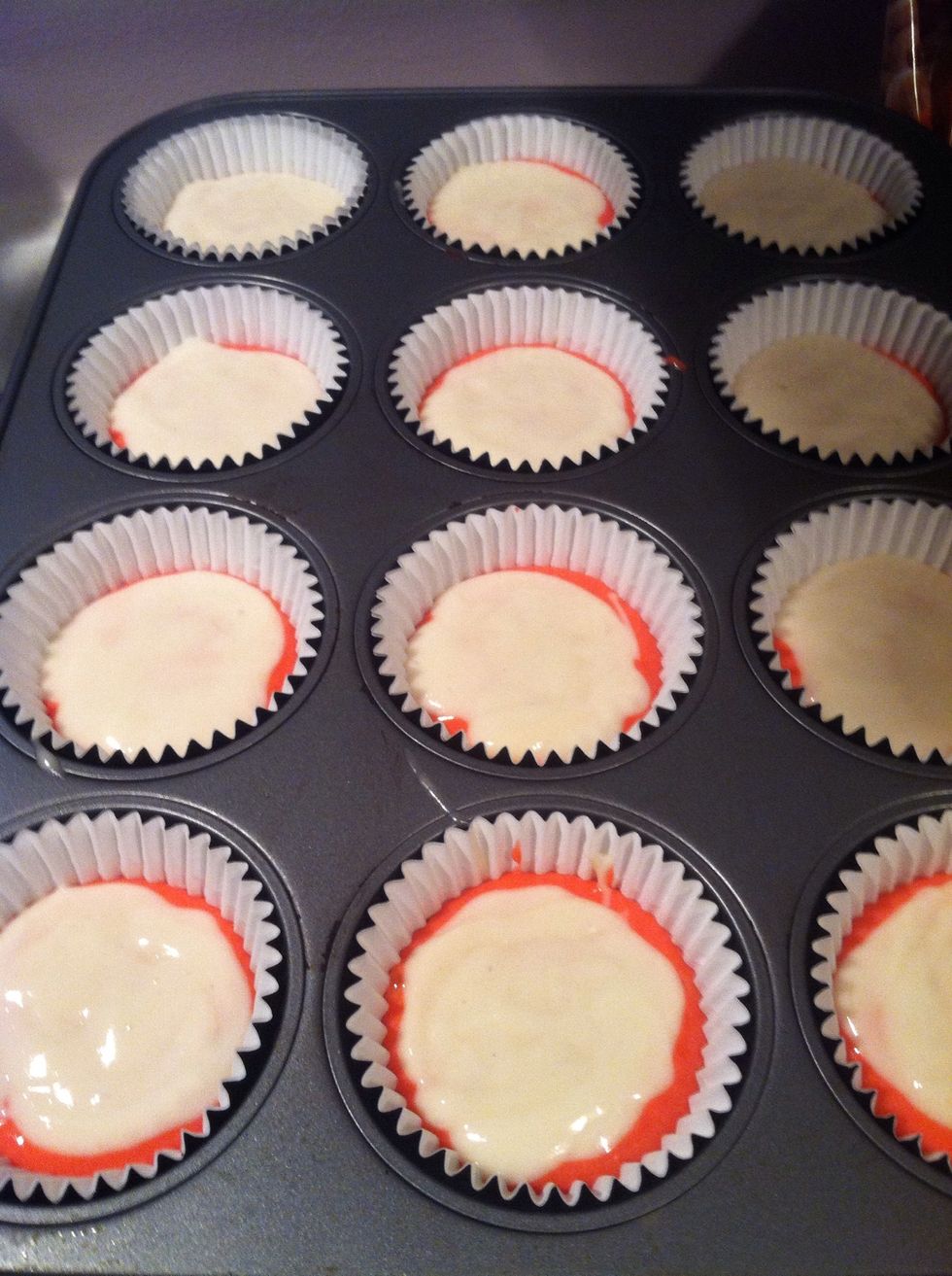 Finish the white batter by putting spoonfuls on top of the red batter. I didn't have enough white batter to cover all the red batter up. Don't dye too much of the batter red!