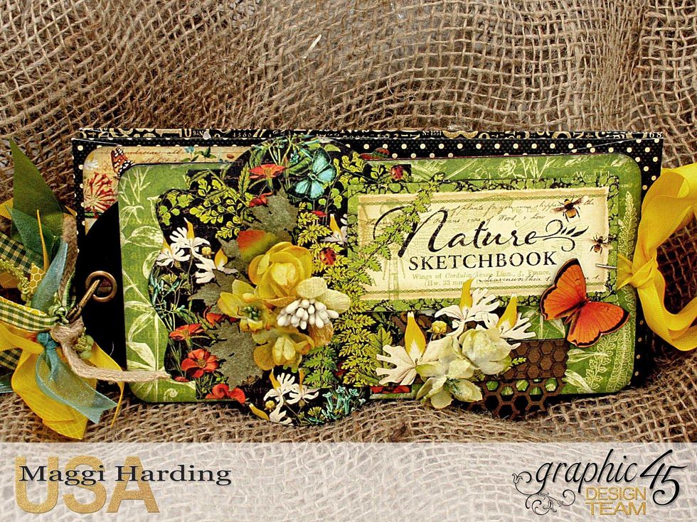 Finish up your cover by adding whatever embellishments you like.  I've added some Petaloo Botanica Minis, Creative Embellishments chipboard leaves and fussy cut butterfly.