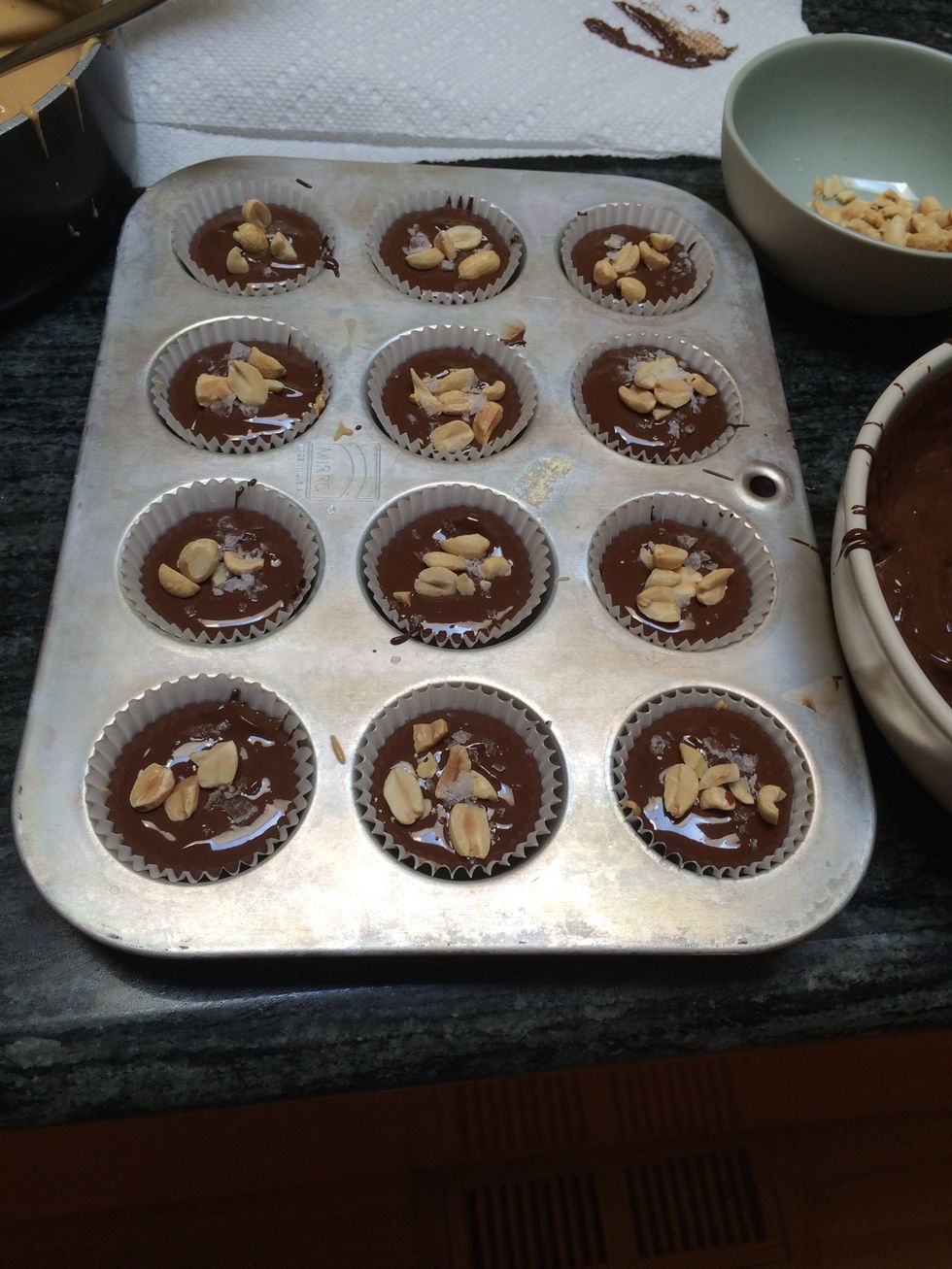 Finish with a final layer of chocolate, a sprinkle of peanuts, and a sprinkle of sea salt.