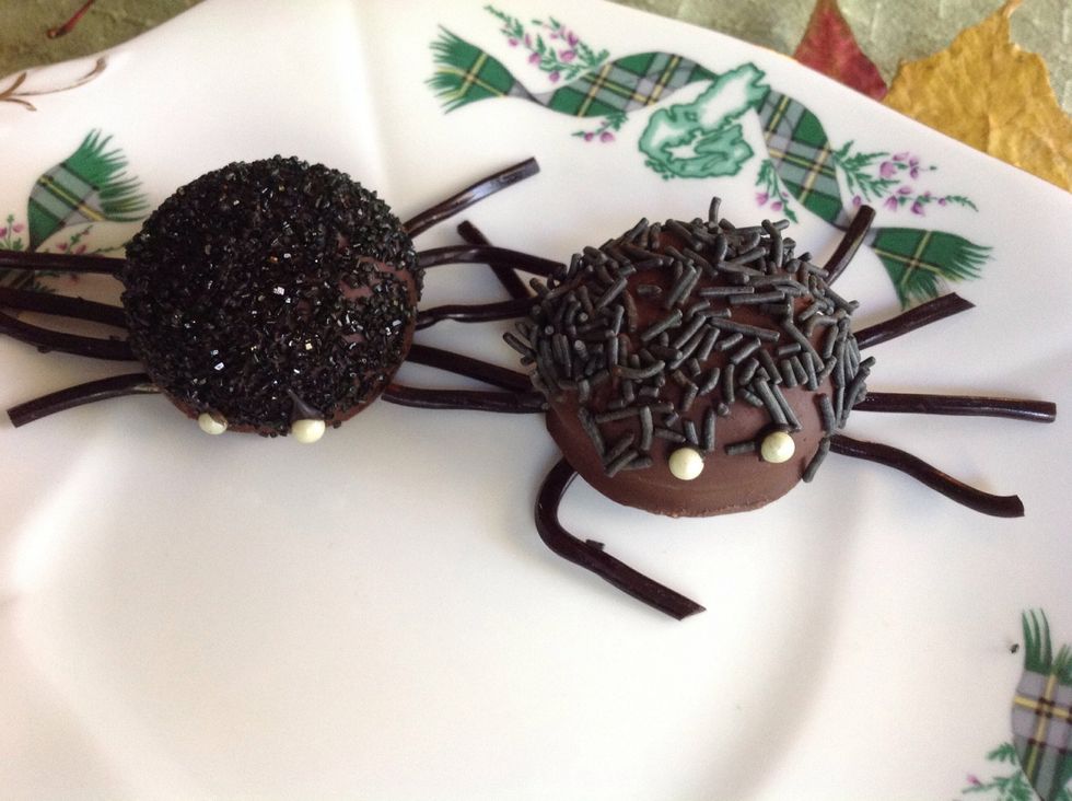 Finish with black licorice for legs and candy balks for eyes. I dipped in melted chocolate as a glue.