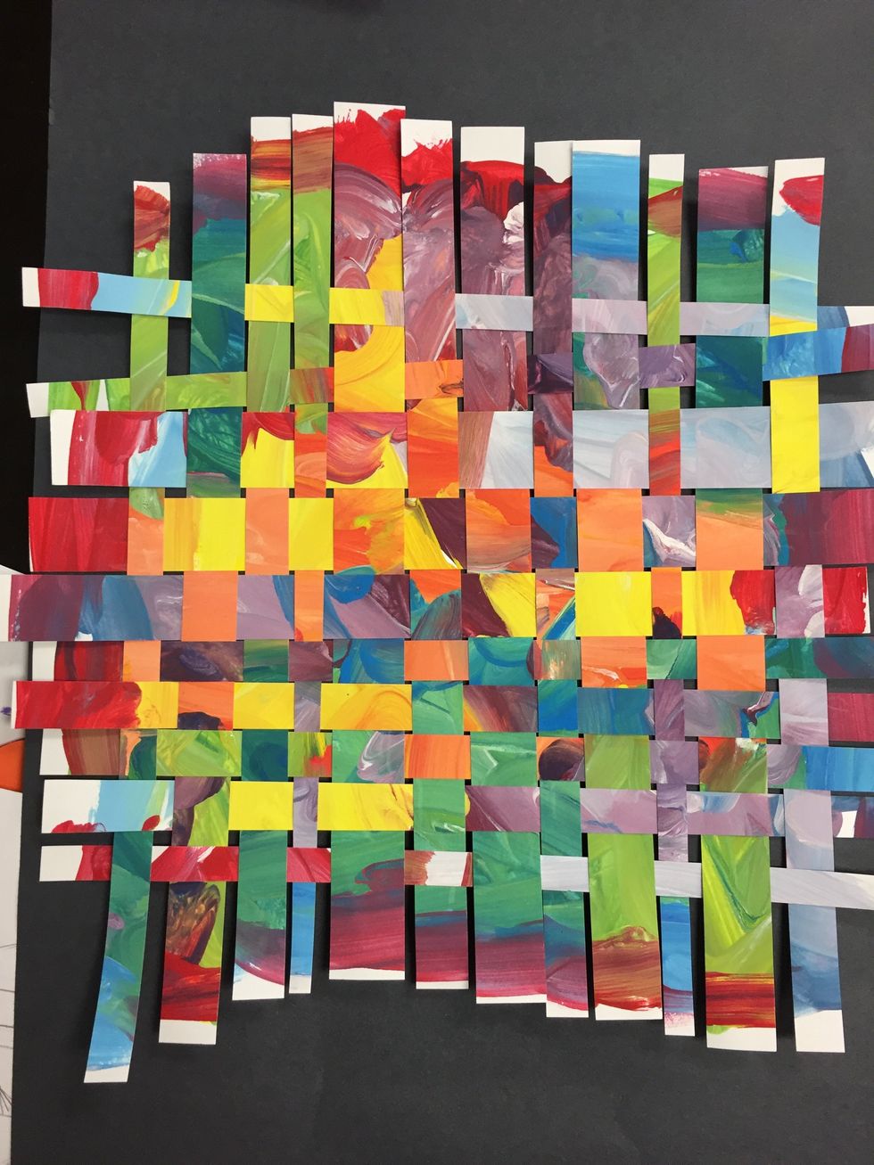 Finished weaving can be glued down to a black sheet of construction paper.