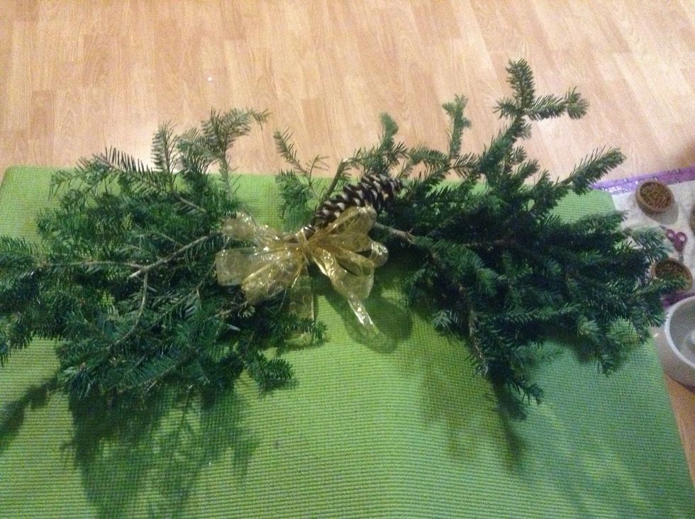 Finished with a bow and a pinecone wrapped in with wire.