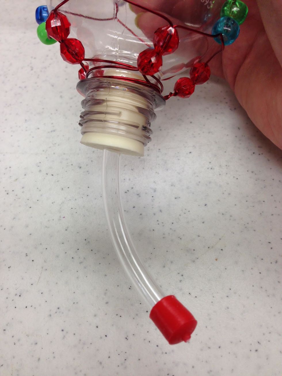 Firmly twist the hummingbird feeder insert into the bottle opening.