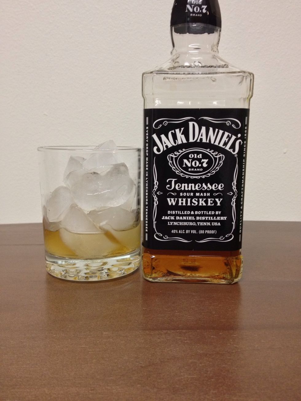 First, add 1 1/2 ounces of Jack Daniels Whiskey into your Rocks glass.
