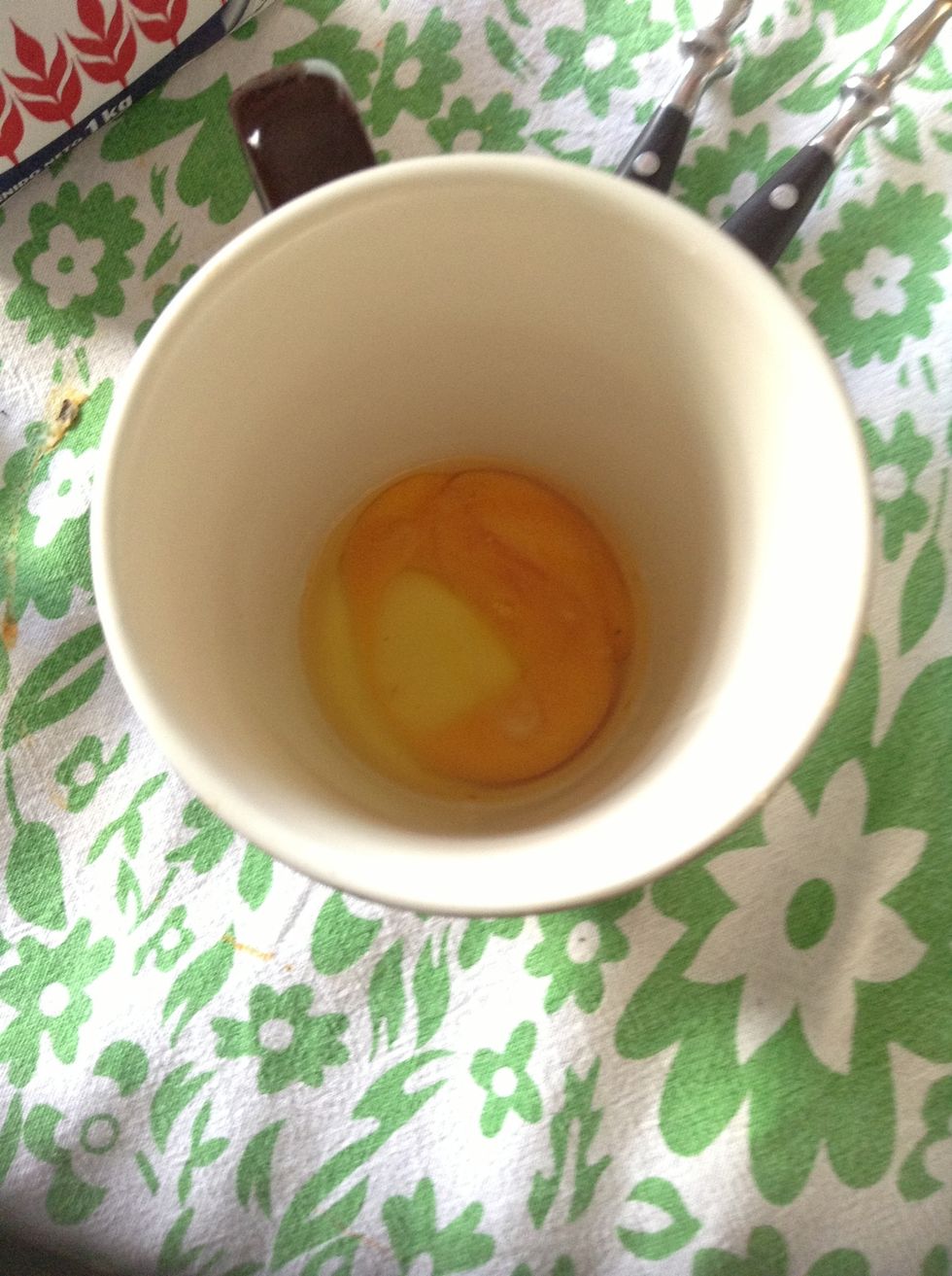 First add an egg to the cup