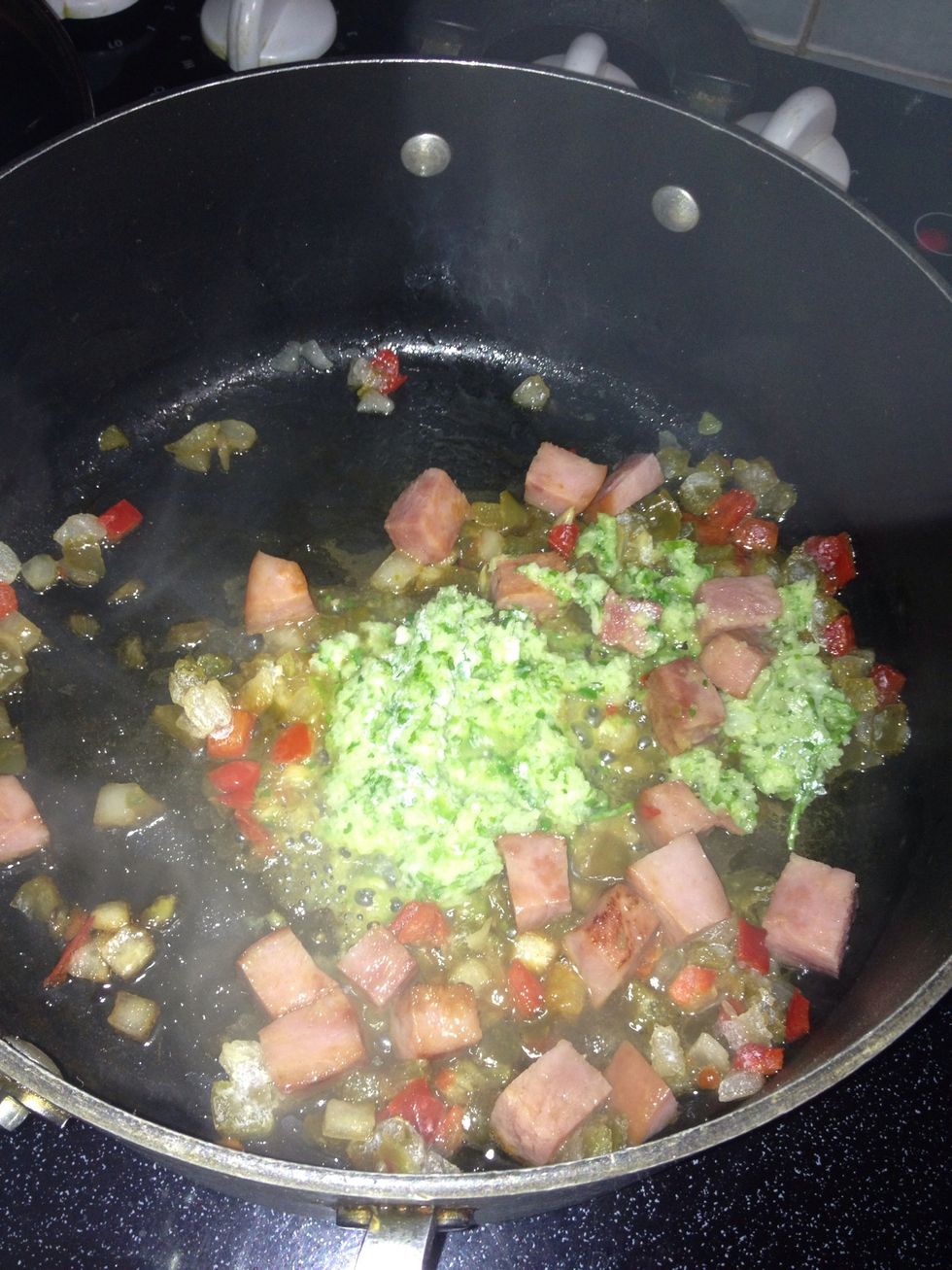 First add the ham a let it cook for 2-3 mints. Later, add the sofrito. Mix all the ingredients, and let the flavors to blend. Be careful not to let it burn.
