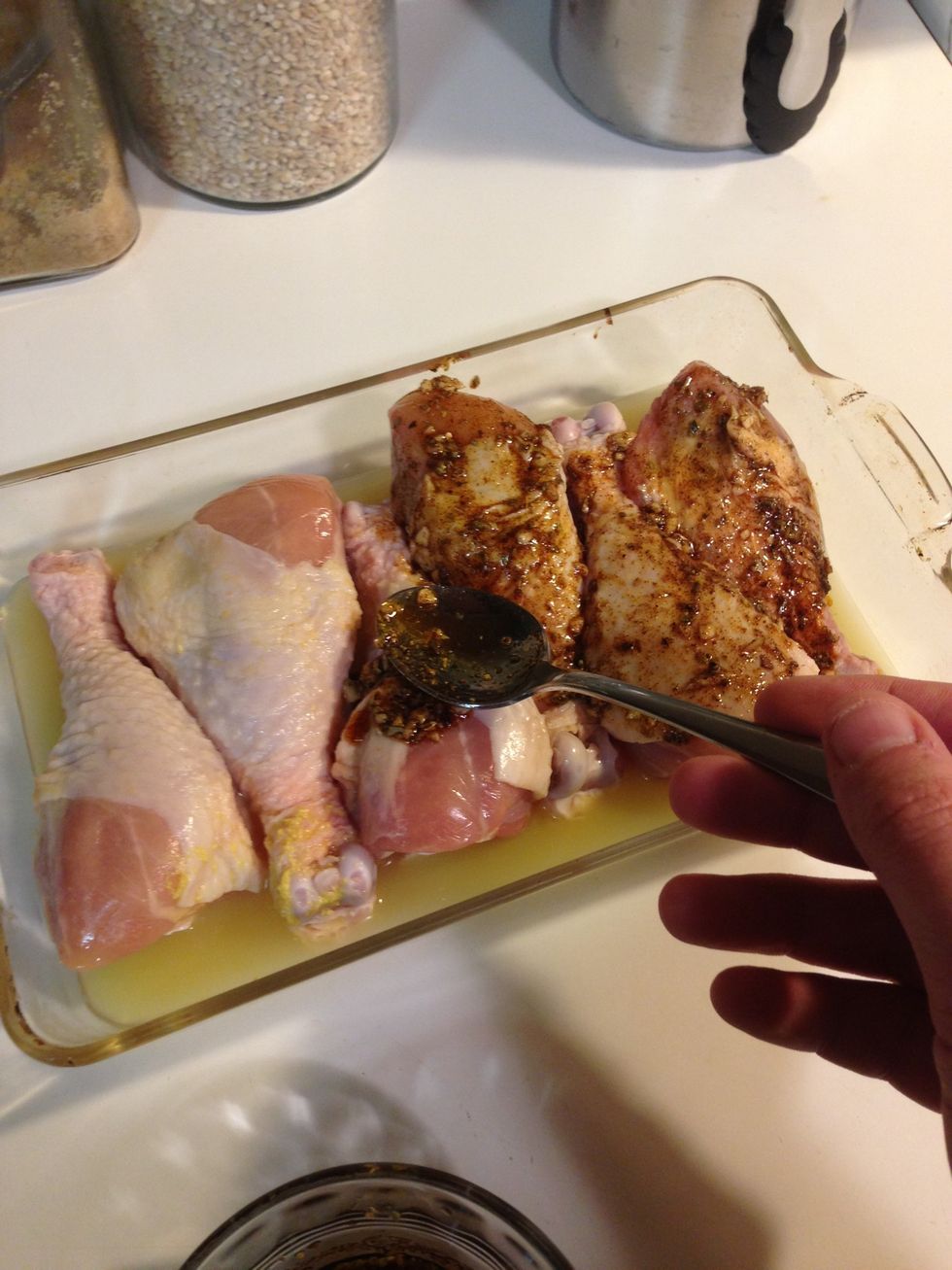 First, add your chicken broth to the bottom of the baking dish. Then rub your paste all over the chicken. Use all of it or some of it, depending on your taste.