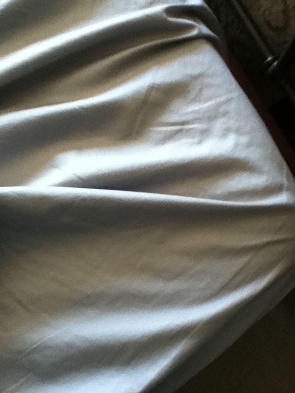 First add your fitted sheet onto the bed and tuck in the corners so it will stay