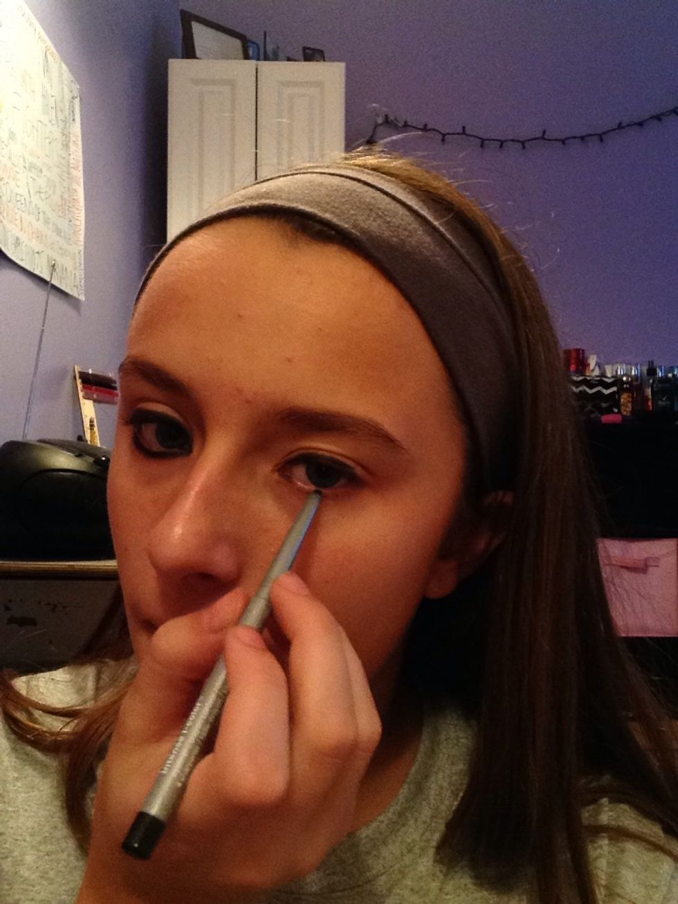 First apply a thick layer of black eyeliner to your eyes