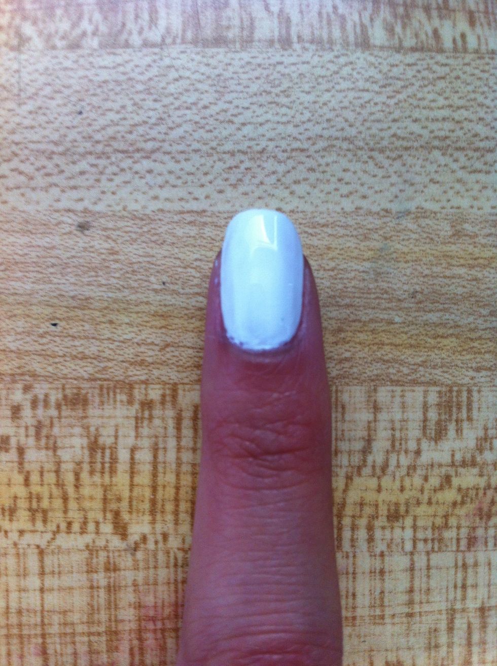 First, apply base coat. Then, paint your nails white.