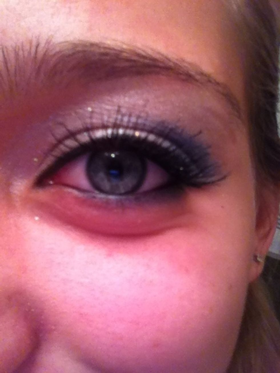 First applying mascara to the top lashes.