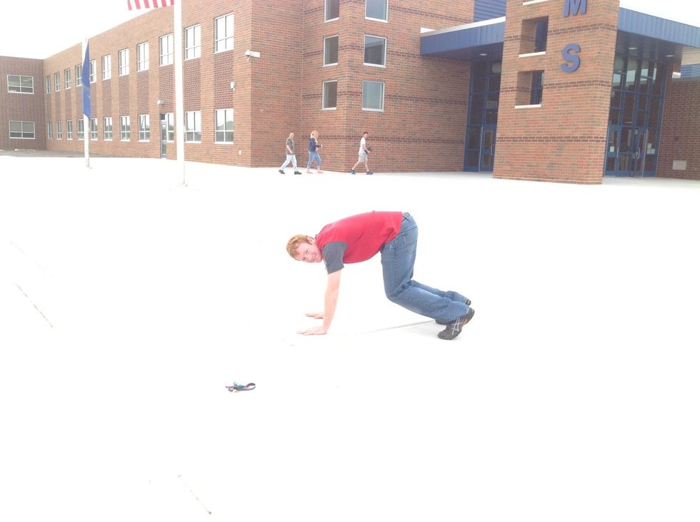 First, bend over and put your hands on the ground.