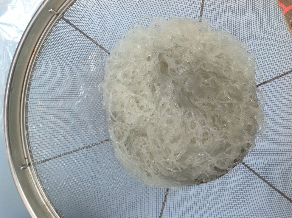 First, boil the water then put the noodles in and stir them around until the noodles are soft and cooked. Pour the water out and put the noodles in a bowl to let it cool down.