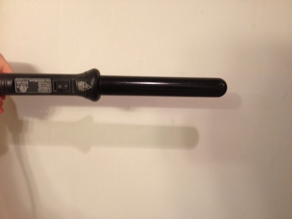 First: brush your hair and start to separate it into sections. Leave the section you want to start with down. Wrap your hair around the barrel of the curler and hold it for 8-10 seconds.