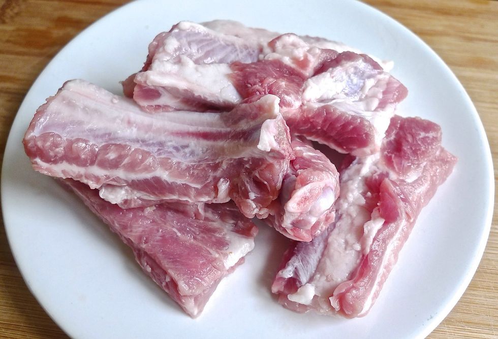 First clean the pork ribs.Use a sharp knife to cut the top fat along the top side of the ribs making sure all the tough tissues that connect the meat are removed.