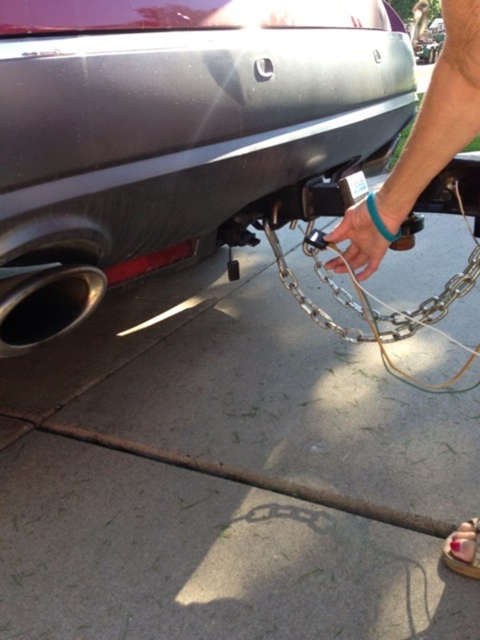 First, connect your vehicle to the hitch. Then, connect the electrical connections for brake and signal lights.
