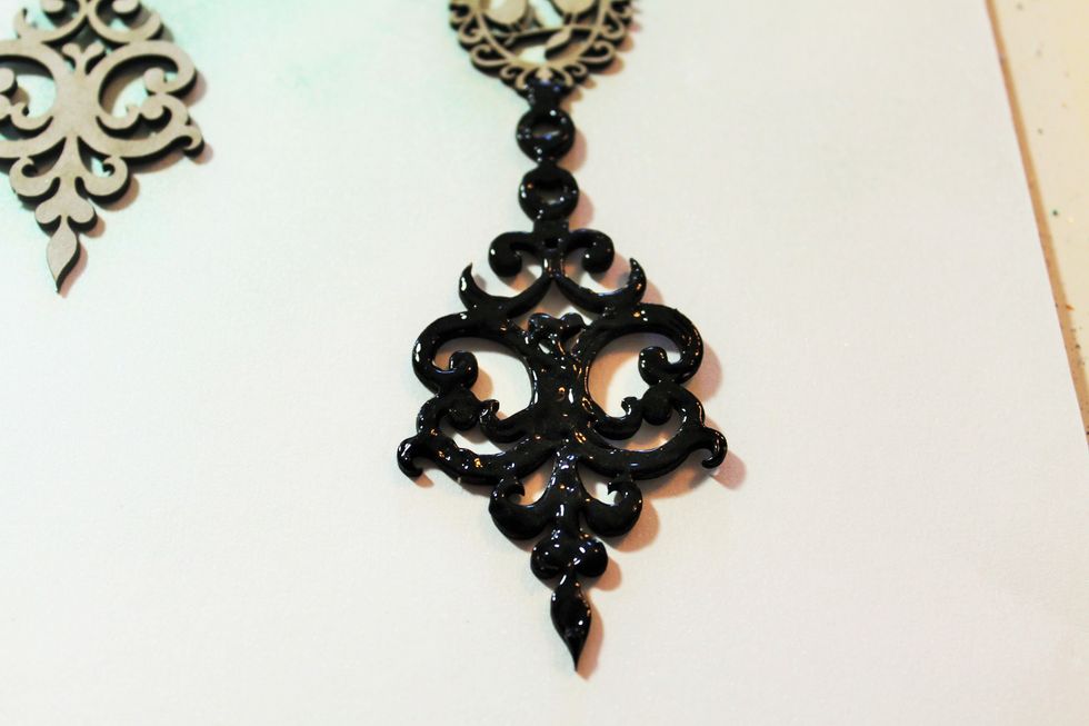 First, cover the chipboard piece with the dimensional paint. The coverage does not need to be even. Again, this is a technique I learned from Rae. She used Perfect Pearls-you could here, too.