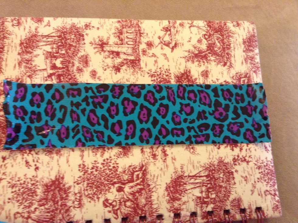 First cut a piece of duct tape about one inch longer than the size of your wrist