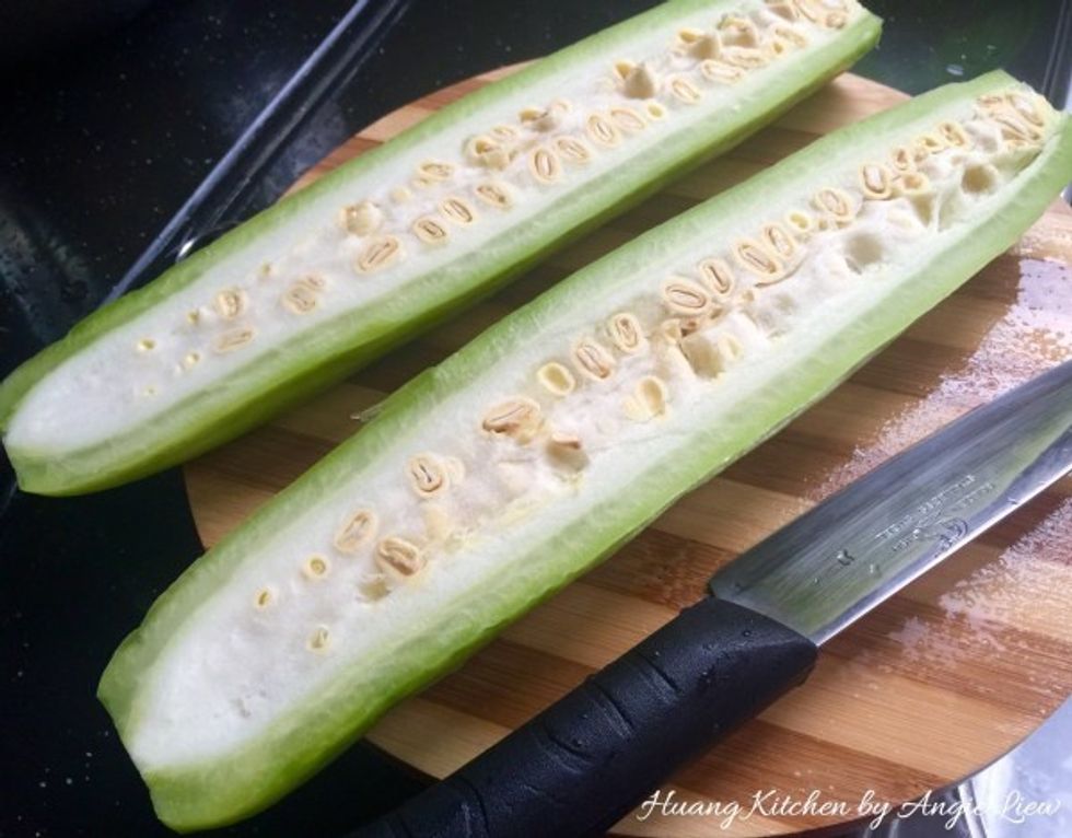First cut bitter gourd into half lengthwise.