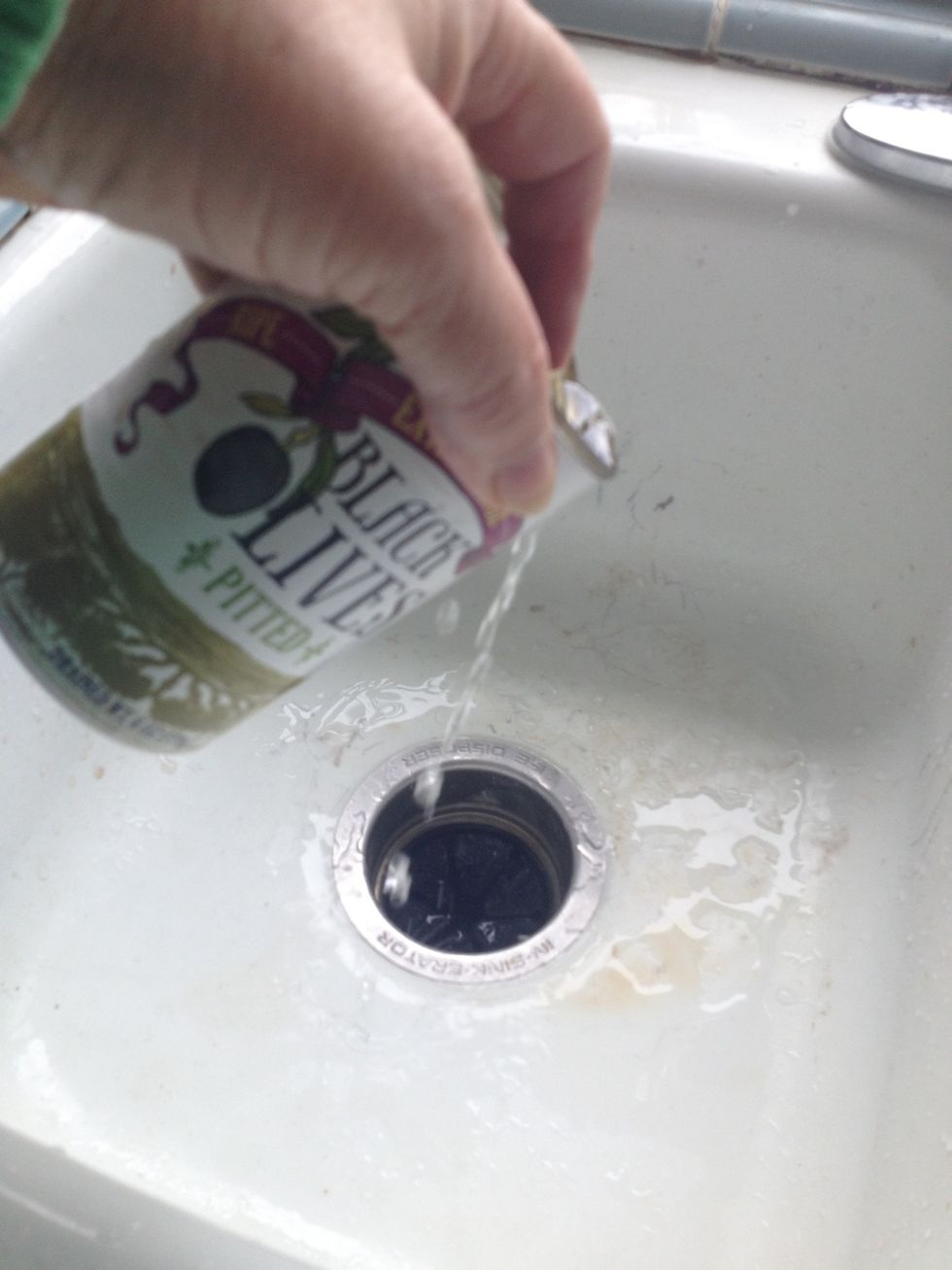 First - Drain one can of pitted large black olives.