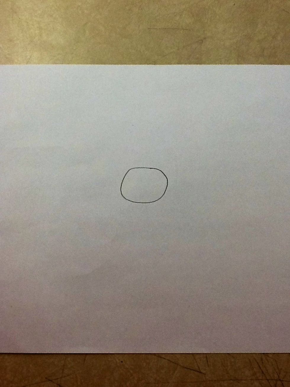 First, draw a circle in around the middle of your paper, with your pencil or pen.