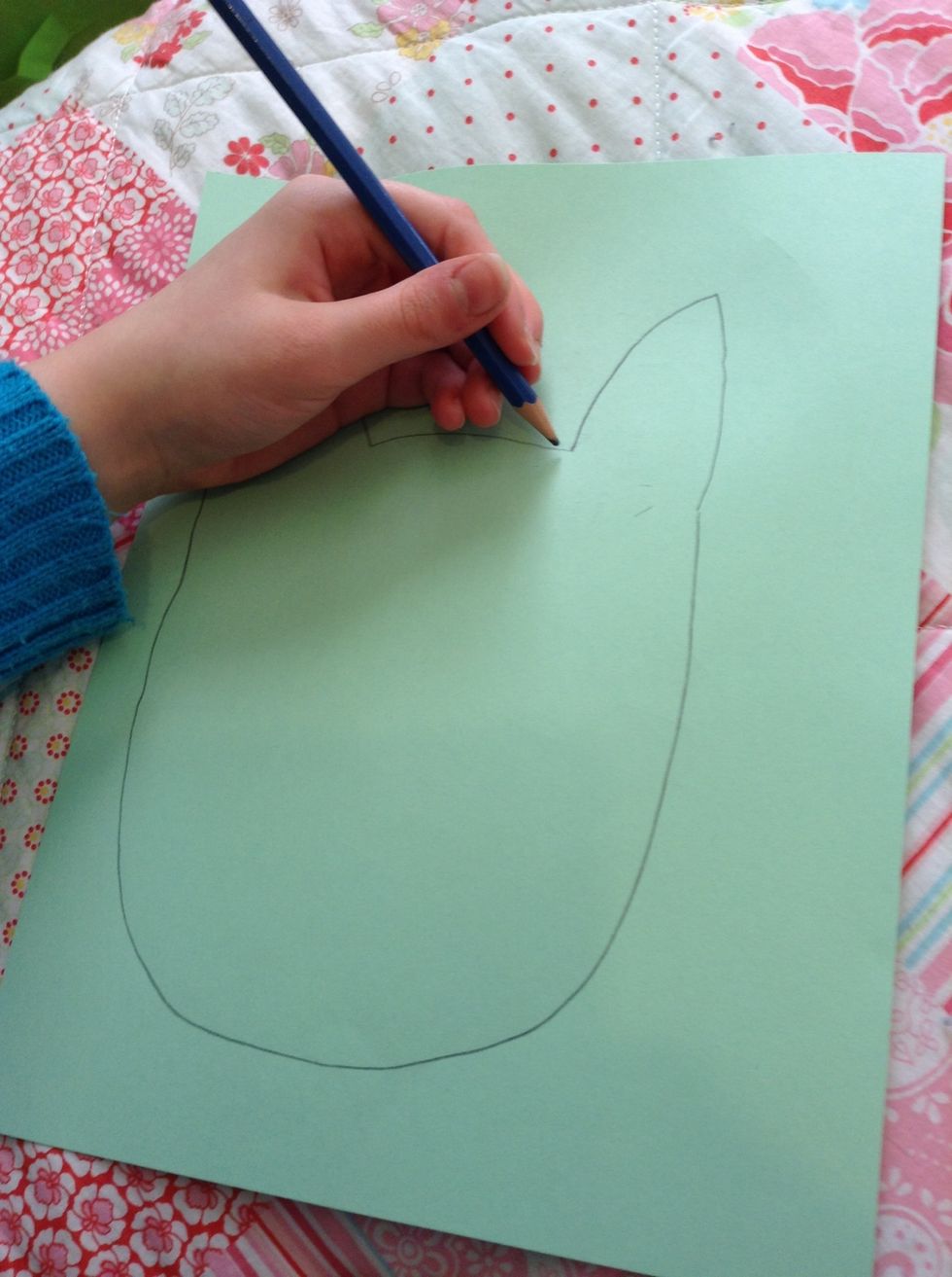 First: draw the body. An oval with ears.