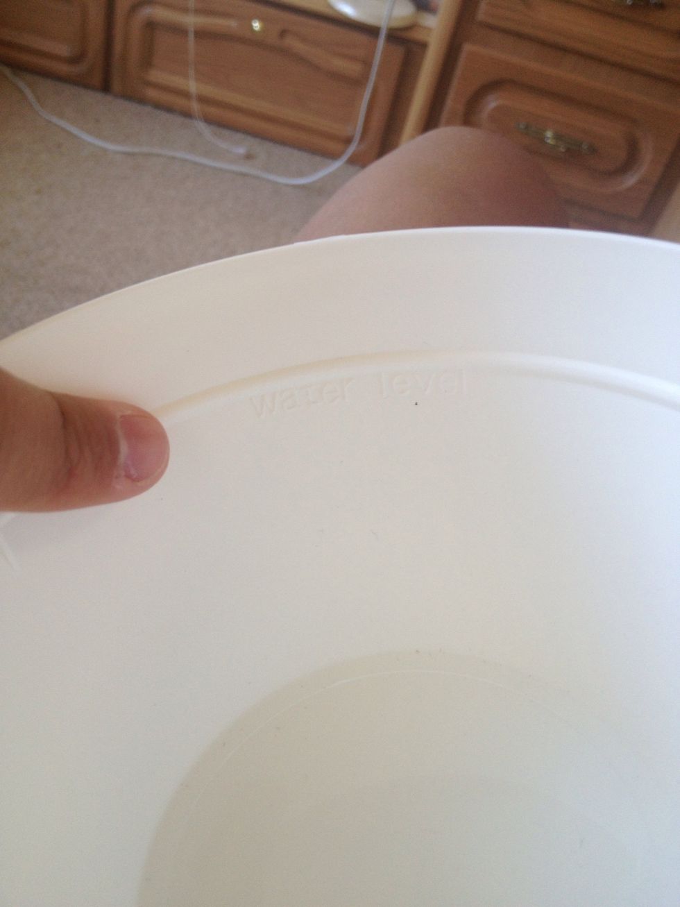 First fill the base with water up to the mark.