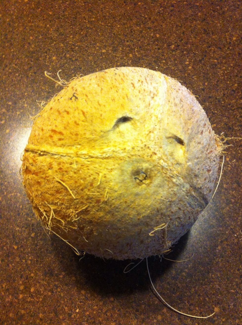First, find the softest of the three spots on the bottom of the coconut.