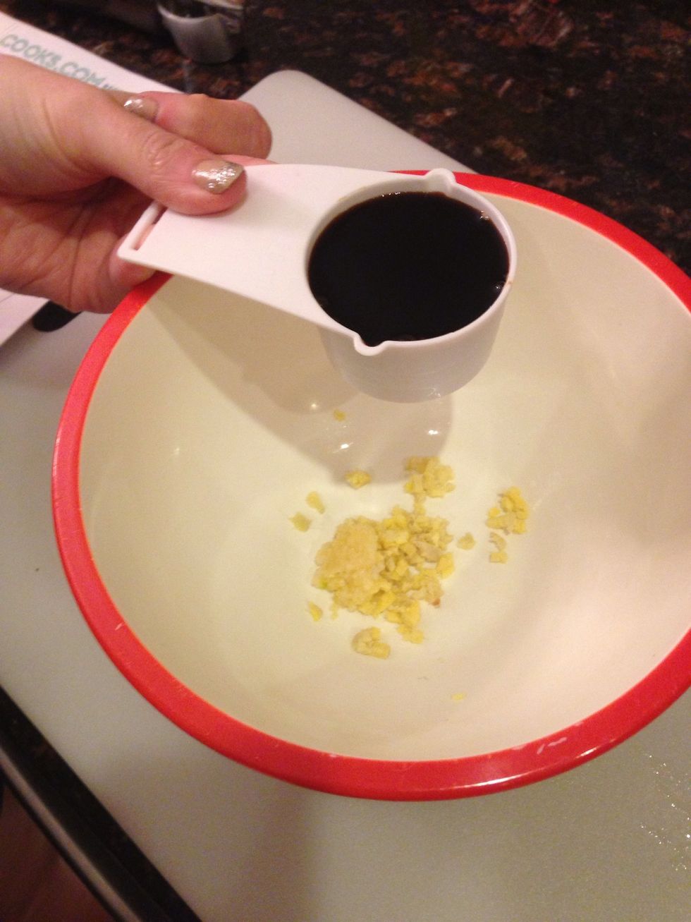 First, finely mince your garlic and ginger. Put into a bowl and add your soy sauce.