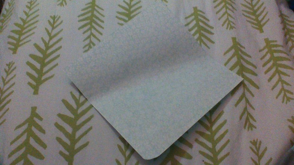 First, flip your paper over so whatever color on bottom is showing and rotate the paper so a corner is pointing at you.