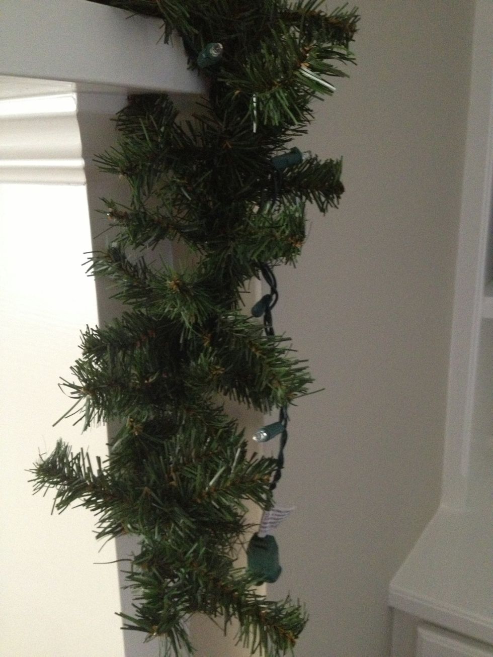 First, fluff and lay your plain garland across your mantle. Make sure it looks full and has a good shape.