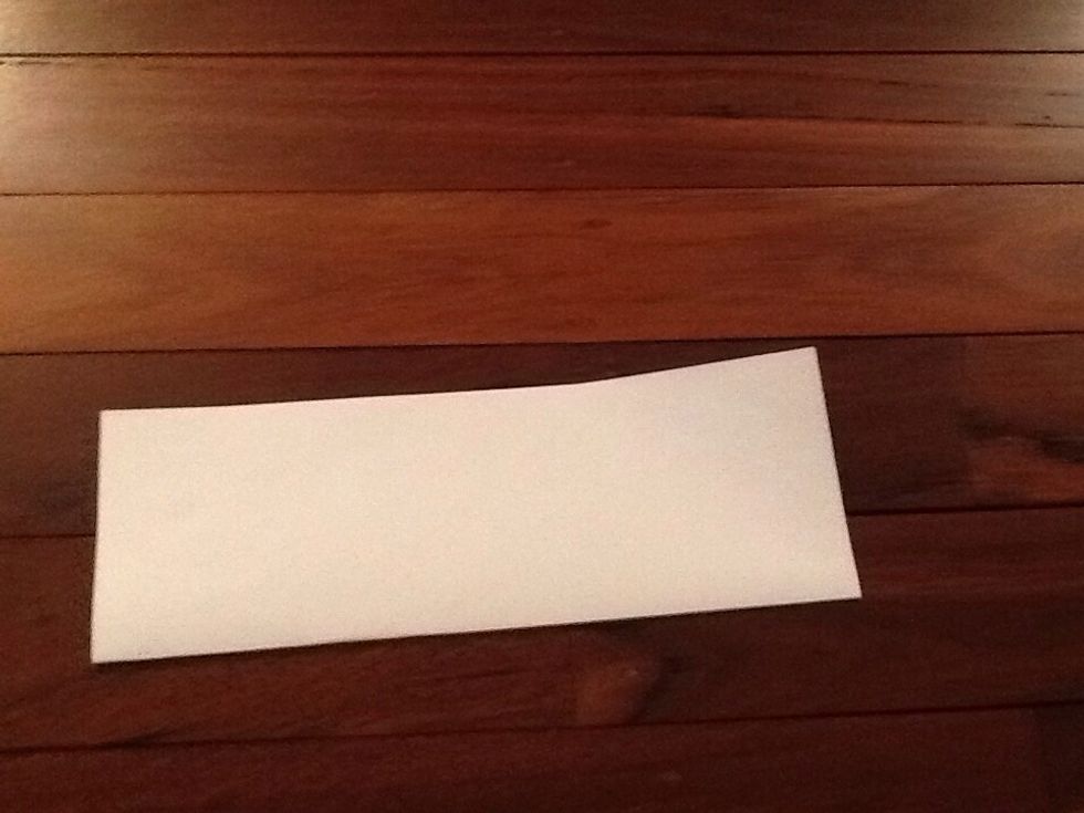 First fold the paper in half long ways.