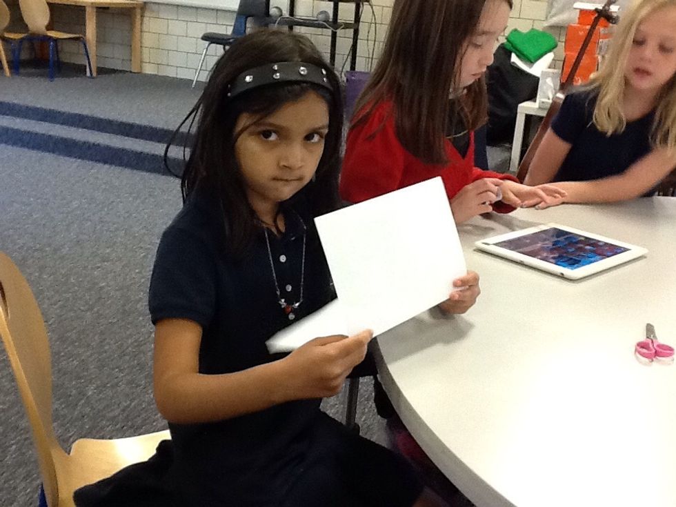 First, fold the paper in half.