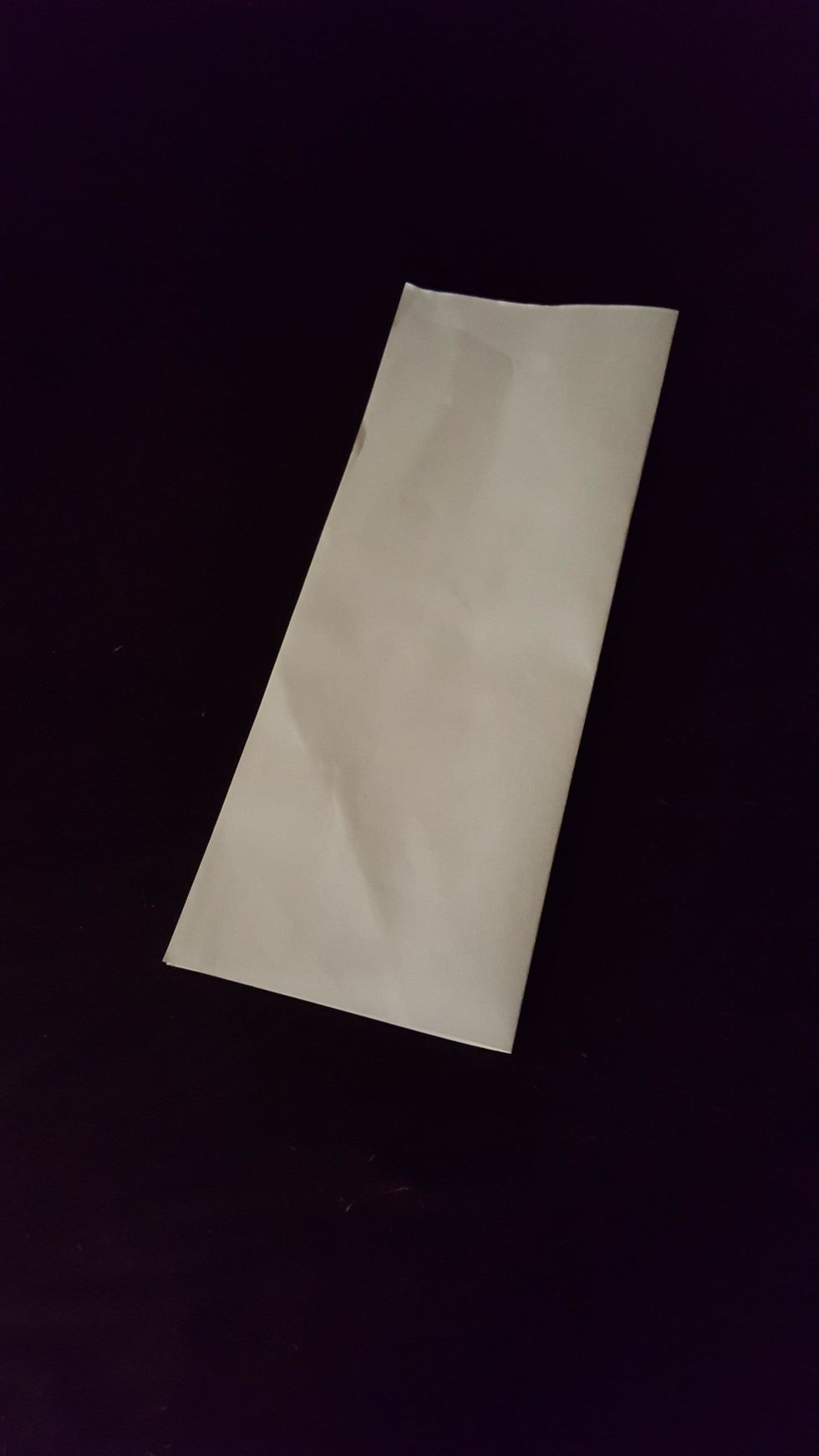 First, fold the paper like a hotdog bun.