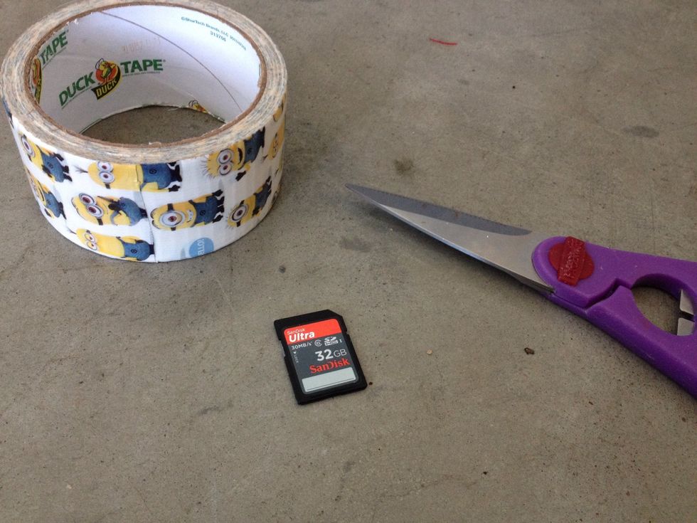 First, gather your "supplies." As shown in the picture, you'll need duct tape, your SD card, and a pair of scissors. Make sure you use minion duct tape. This is absolutely vital. \ud83d\ude09